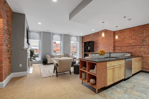 A kitchen with a brick wall and a counter top.at The Granite Works Apartments , Buffalo, NY